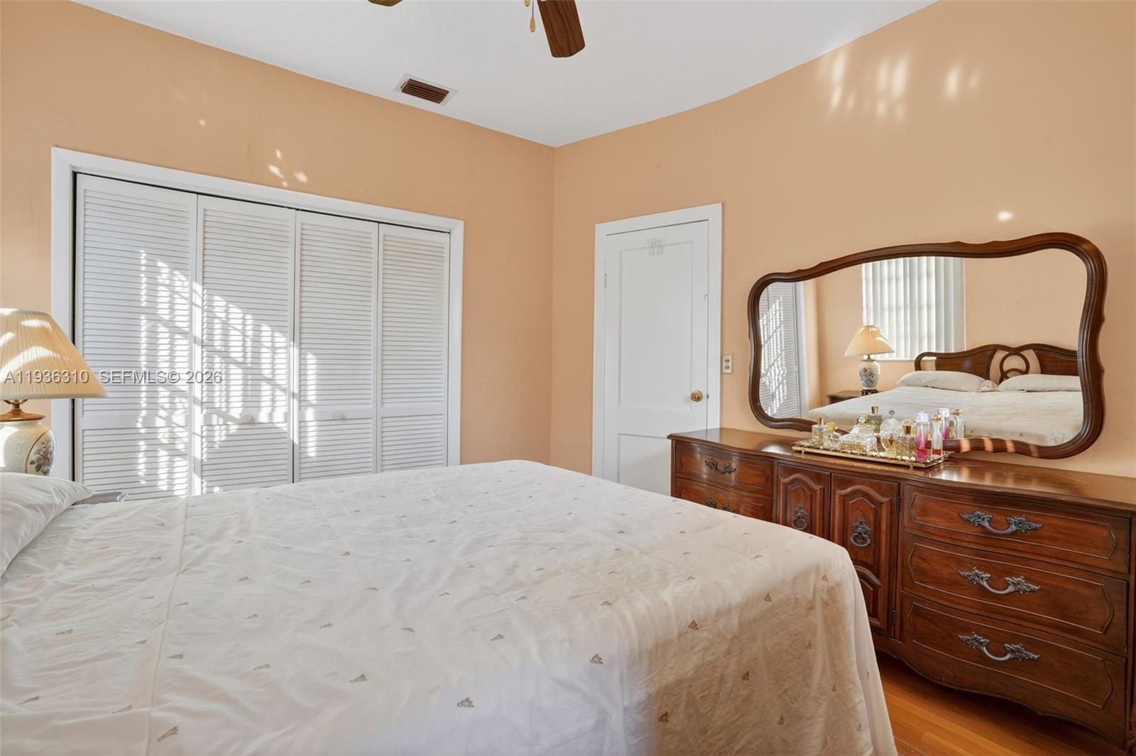 1633 Southwest 30th Avenue Miami, FL 33145 - Photo 17 of 30 a bedroom with a bed and dresser with mirror