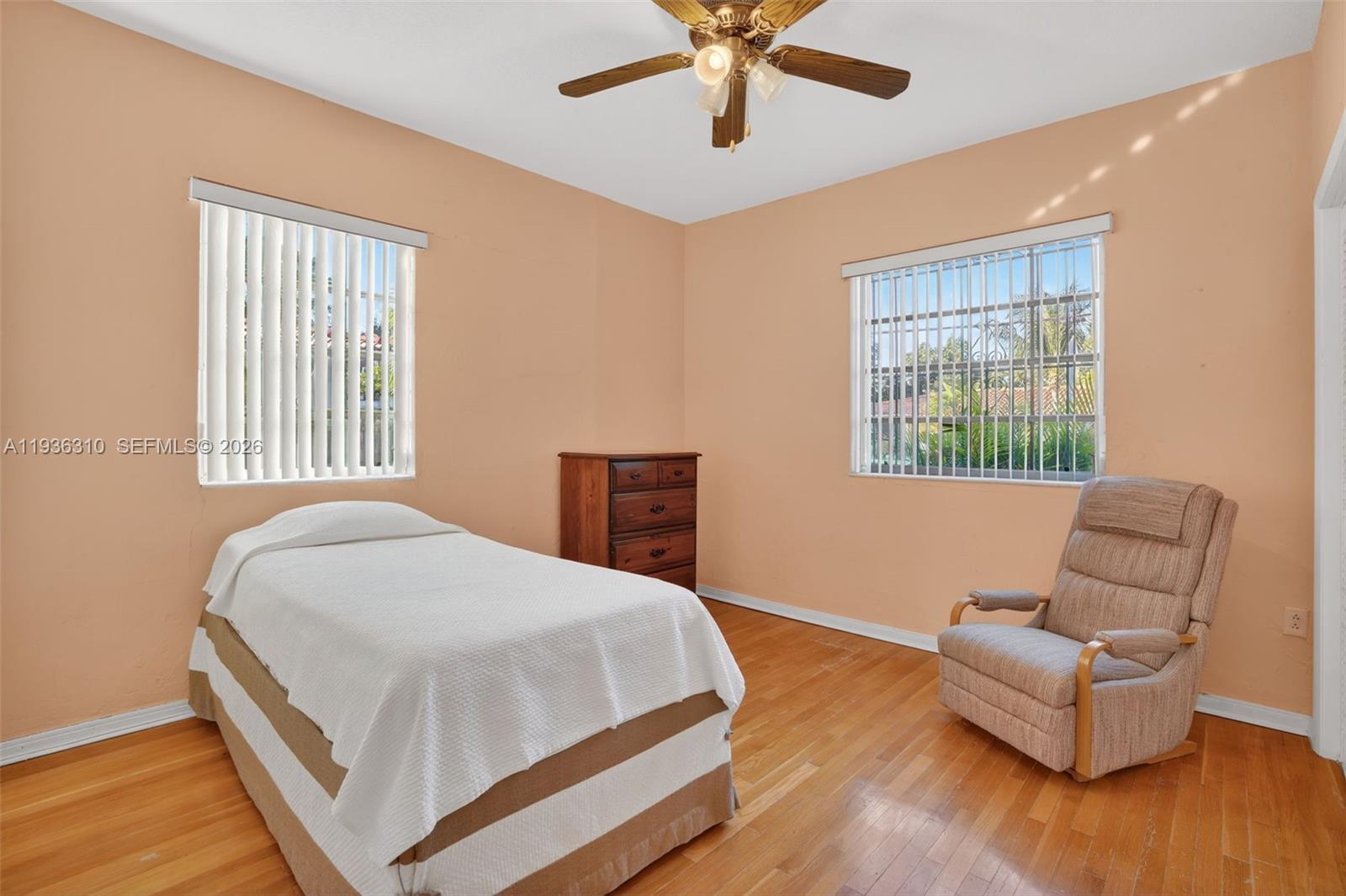 1633 Southwest 30th Avenue Miami, FL 33145 - Photo 19 of 30 a bedroom with a bed and wooden floor