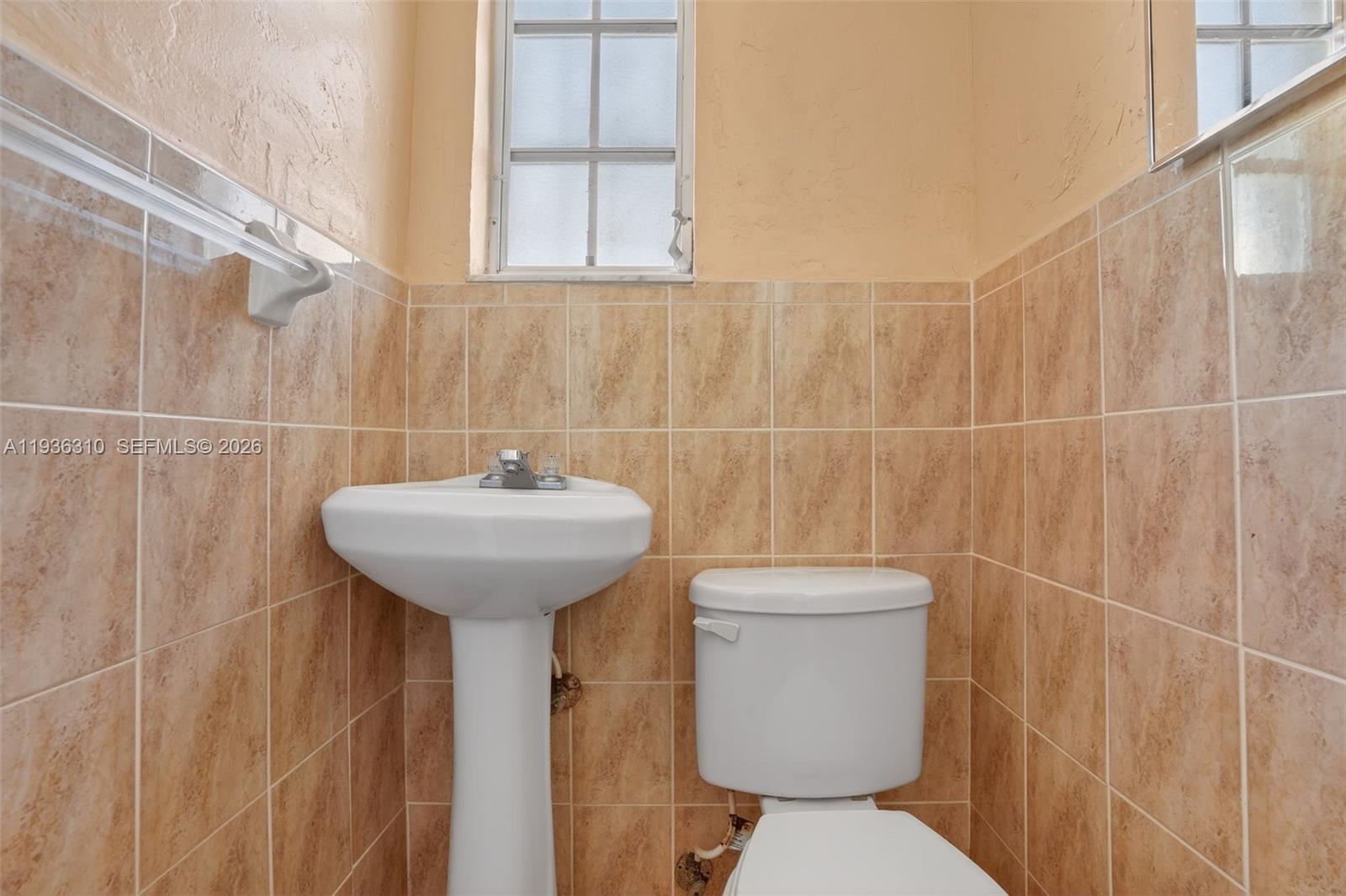 1633 Southwest 30th Avenue Miami, FL 33145 - Photo 21 of 30 a bathroom with a sink toilet and a mirror
