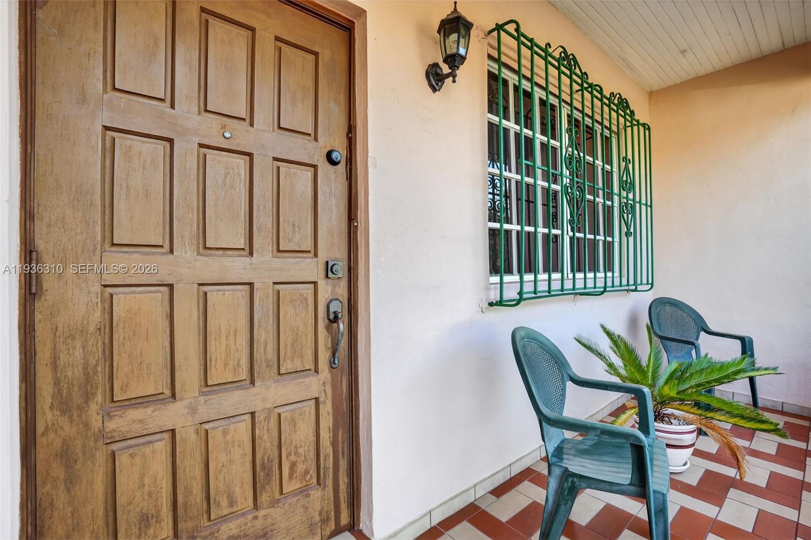 1633 Southwest 30th Avenue Miami, FL 33145 - Photo 3 of 30 a view of a porch with a table and chairs