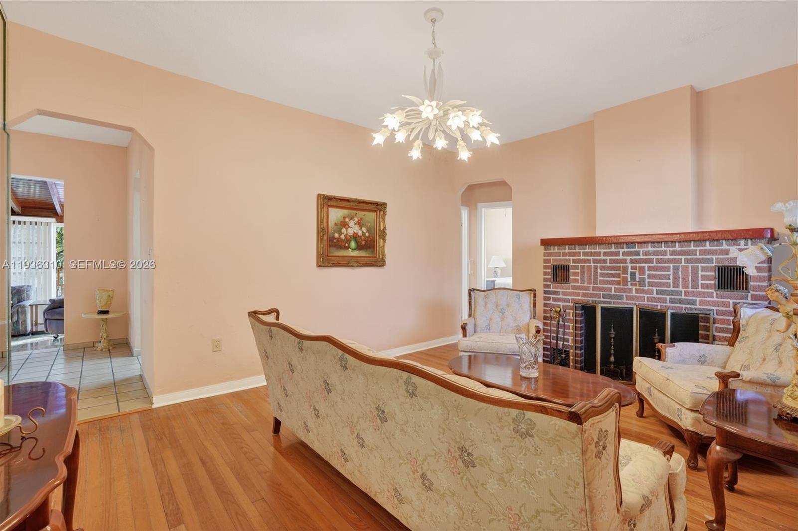 1633 Southwest 30th Avenue Miami, FL 33145 - Photo 4 of 30 a view of a dining room with furniture wooden floor fireplace and chandelier