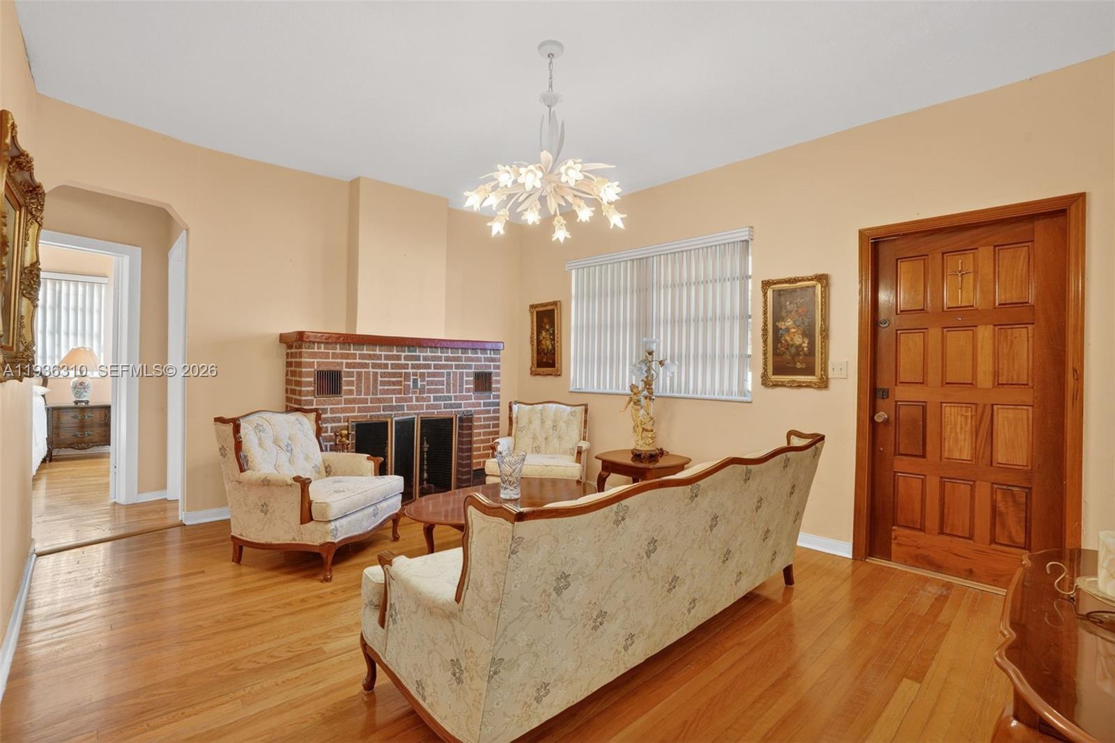 1633 Southwest 30th Avenue Miami, FL 33145 - Photo 5 of 30 a living room with furniture a fireplace and chandelier