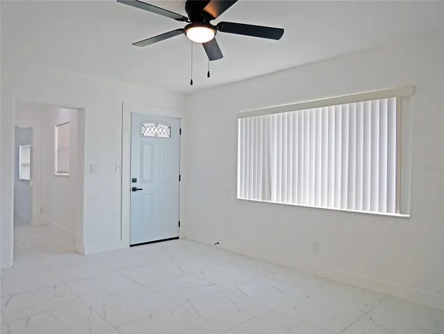 a view of an empty room with a window