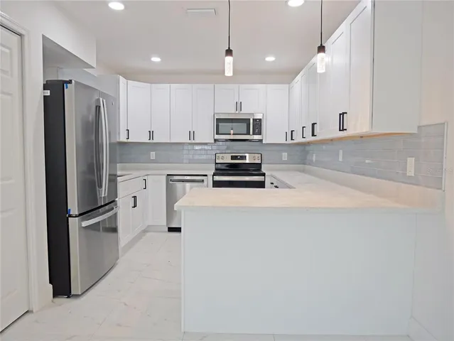 an empty room with a window and a ceiling fan