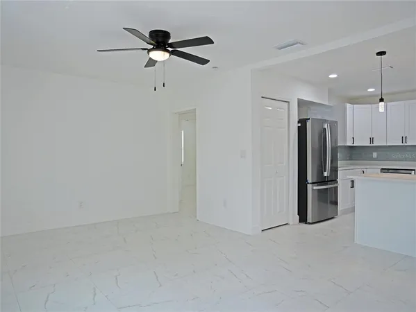 a kitchen with stainless steel appliances a refrigerator sink and cabinets