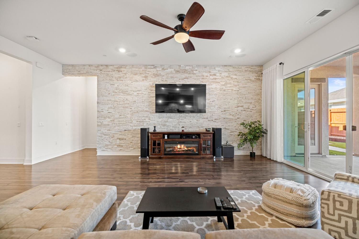 6281 Element Lane Roseville, CA 95747 - Photo 8 of 16 a living room with furniture a fireplace and a flat screen tv