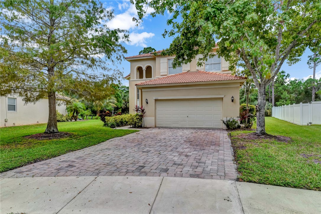 5513 Spanish River Road Fort Pierce, FL 34951 - Photo 1 of 33 a front view of a house with a yard and trees