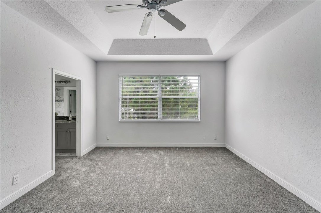 5513 Spanish River Road Fort Pierce, FL 34951 - Photo 15 of 33 an empty room with a window and a ceiling fan