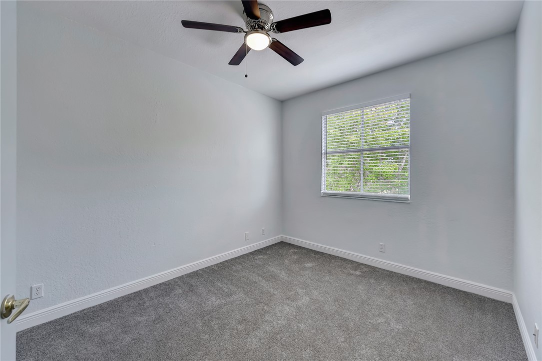 5513 Spanish River Road Fort Pierce, FL 34951 - Photo 21 of 33 an empty room with a window and a fan