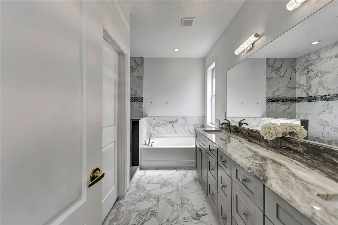 5513 Spanish River Road Fort Pierce, FL 34951 - Photo 26 of 33 a bathroom with a double vanity sink and mirror