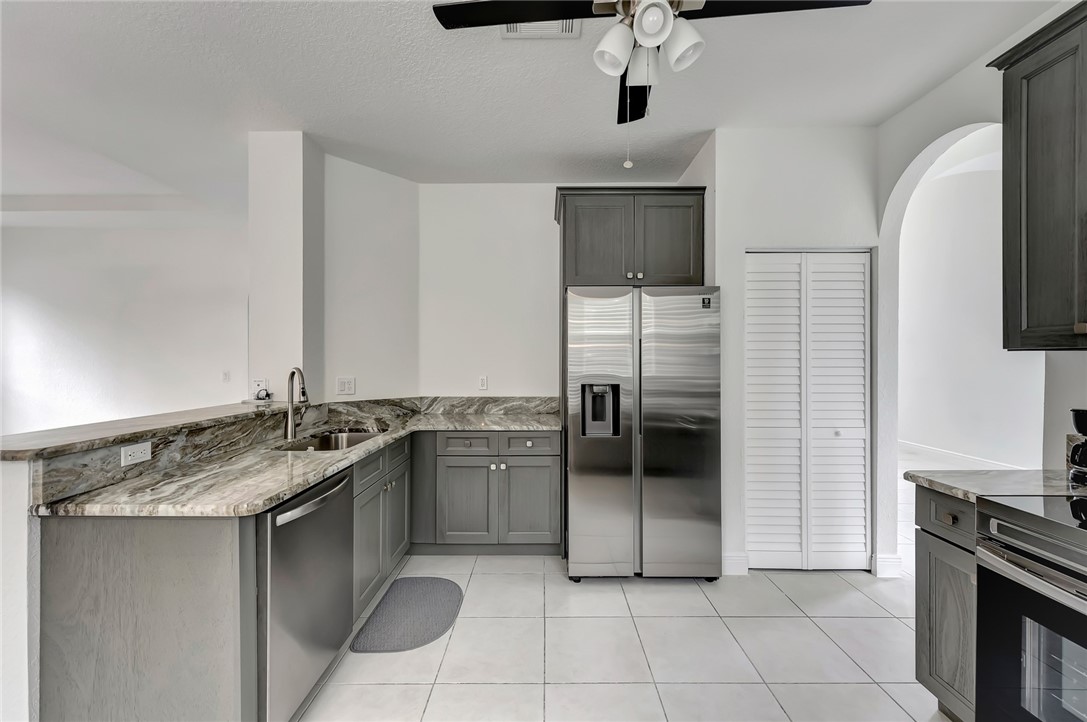 5513 Spanish River Road Fort Pierce, FL 34951 - Photo 3 of 33 a kitchen with stainless steel appliances granite countertop a sink and a stove