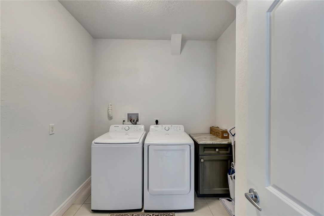 5513 Spanish River Road Fort Pierce, FL 34951 - Photo 31 of 33 a utility room with dryer and washer