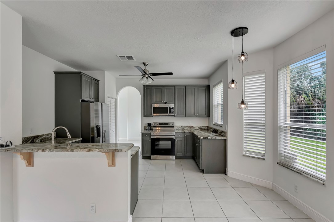 5513 Spanish River Road Fort Pierce, FL 34951 - Photo 4 of 33 a kitchen with a sink appliances and cabinets