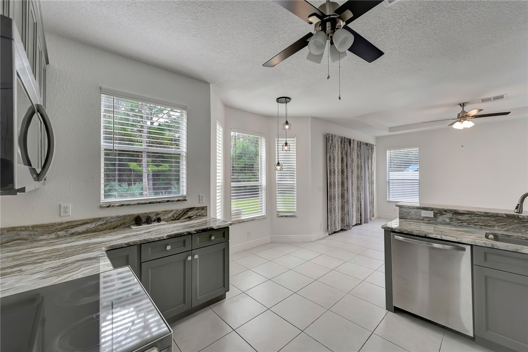 5513 Spanish River Road Fort Pierce, FL 34951 - Photo 6 of 33 a kitchen with granite countertop a sink stainless steel appliances and cabinets