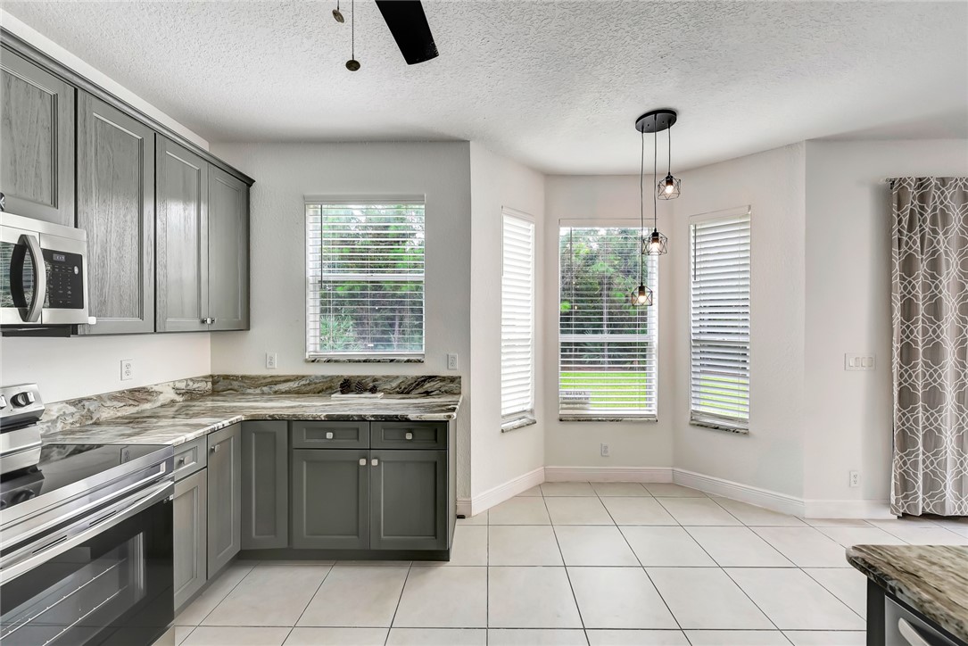 5513 Spanish River Road Fort Pierce, FL 34951 - Photo 7 of 33 a kitchen that has a sink and a stove
