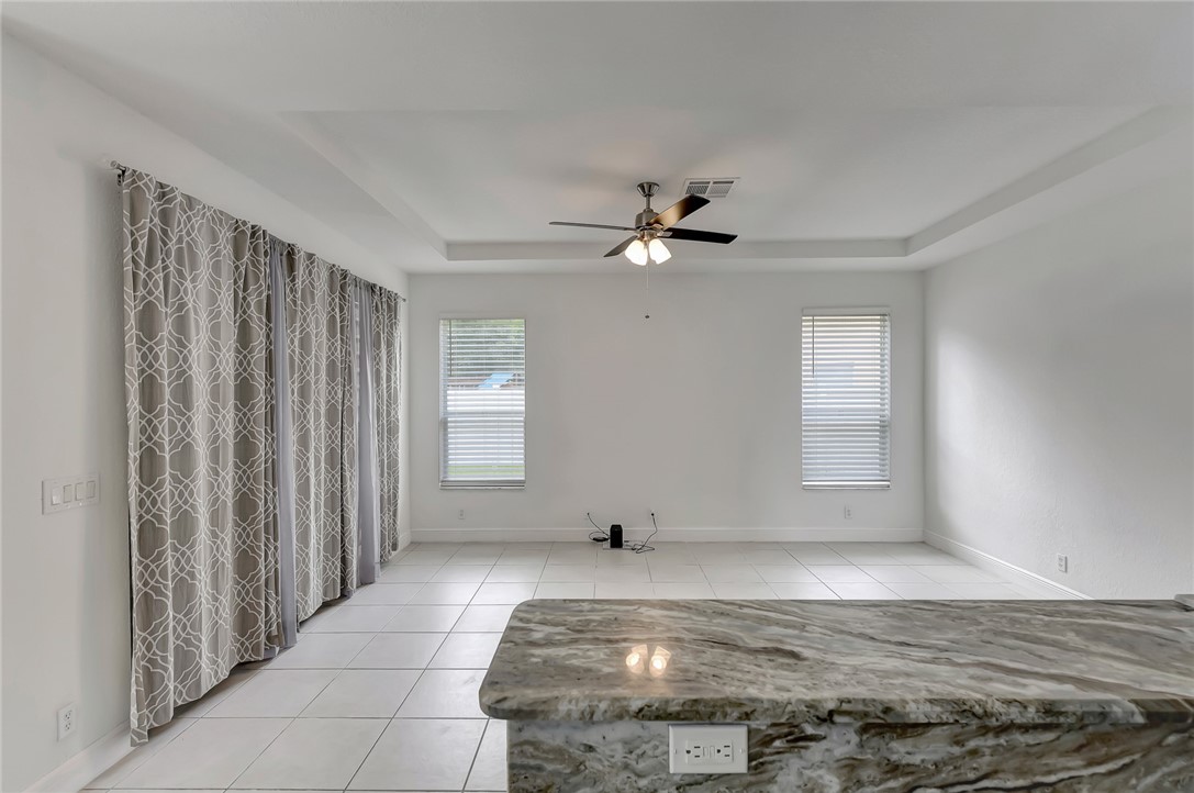 5513 Spanish River Road Fort Pierce, FL 34951 - Photo 8 of 33 a view of an empty room with window and chandelier fan