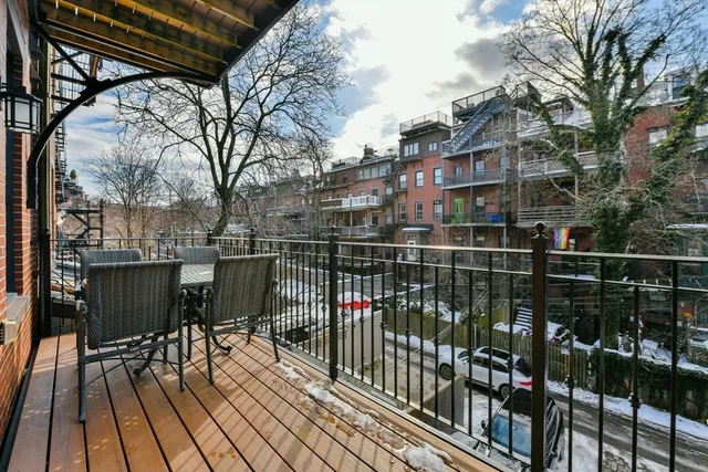 a view of a balcony with wooden floor
