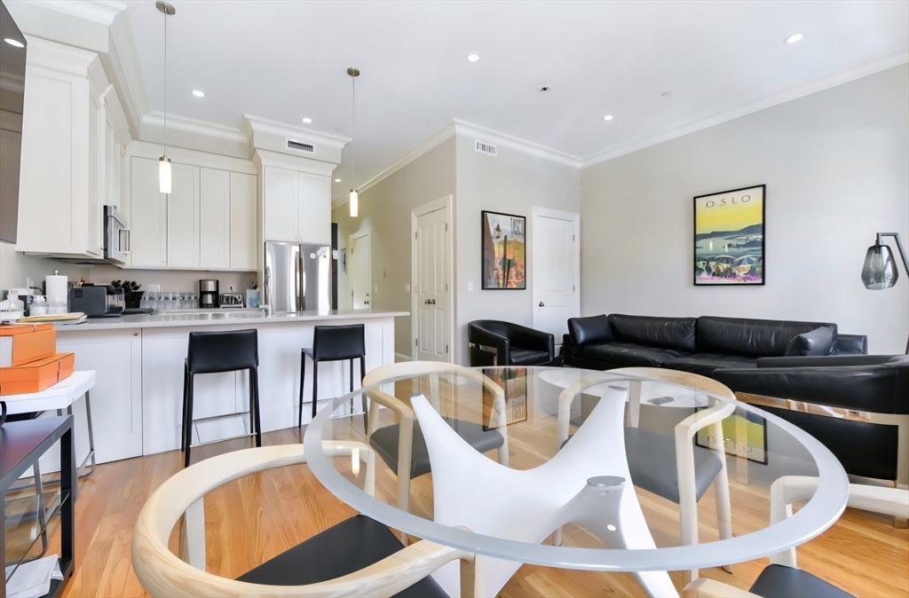 142 West Concord Street, Unit 2 Boston, MA 02118 - Photo 7 of 18 a living room with stainless steel appliances kitchen island granite countertop a dining table chairs and a refrigerator