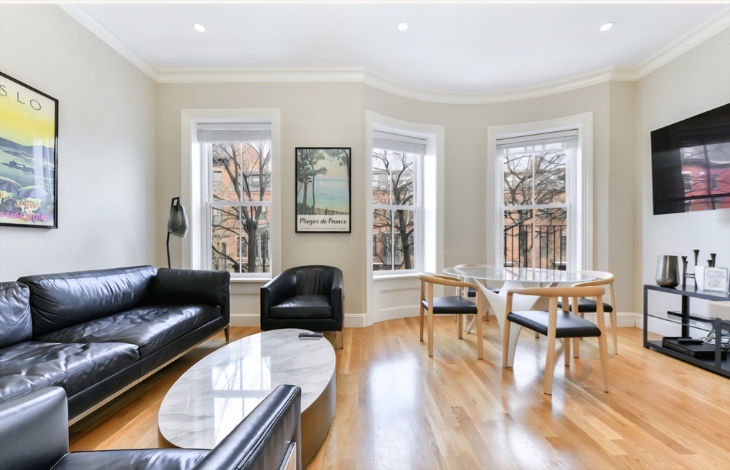 142 West Concord Street, Unit 2 Boston, MA 02118 - Photo 9 of 18 a living room with furniture and floor to ceiling windows