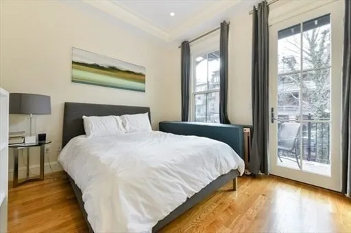 a large bed sitting in a bedroom next to a window
