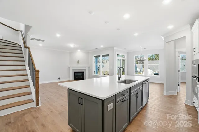 a kitchen with a sink stainless steel appliances and cabinets