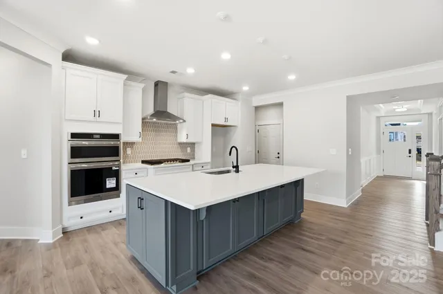 a kitchen with a sink stainless steel appliances and cabinets