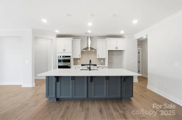 a kitchen with a sink stainless steel appliances and white cabinets