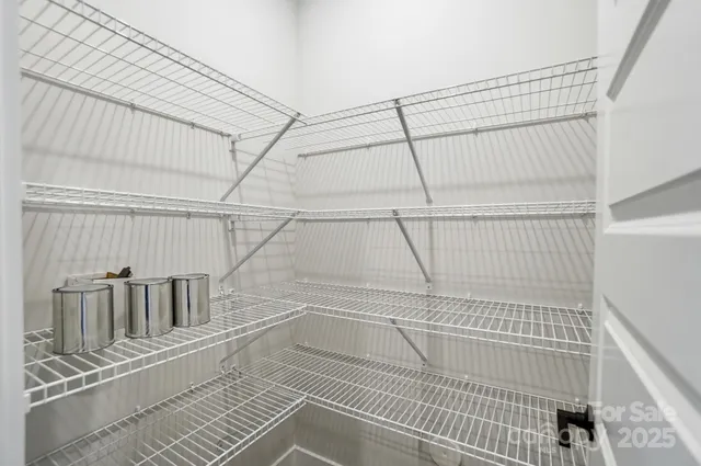 a view of walk in closet with wooden floor