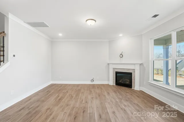 a view of kitchen with wooden floor and a window