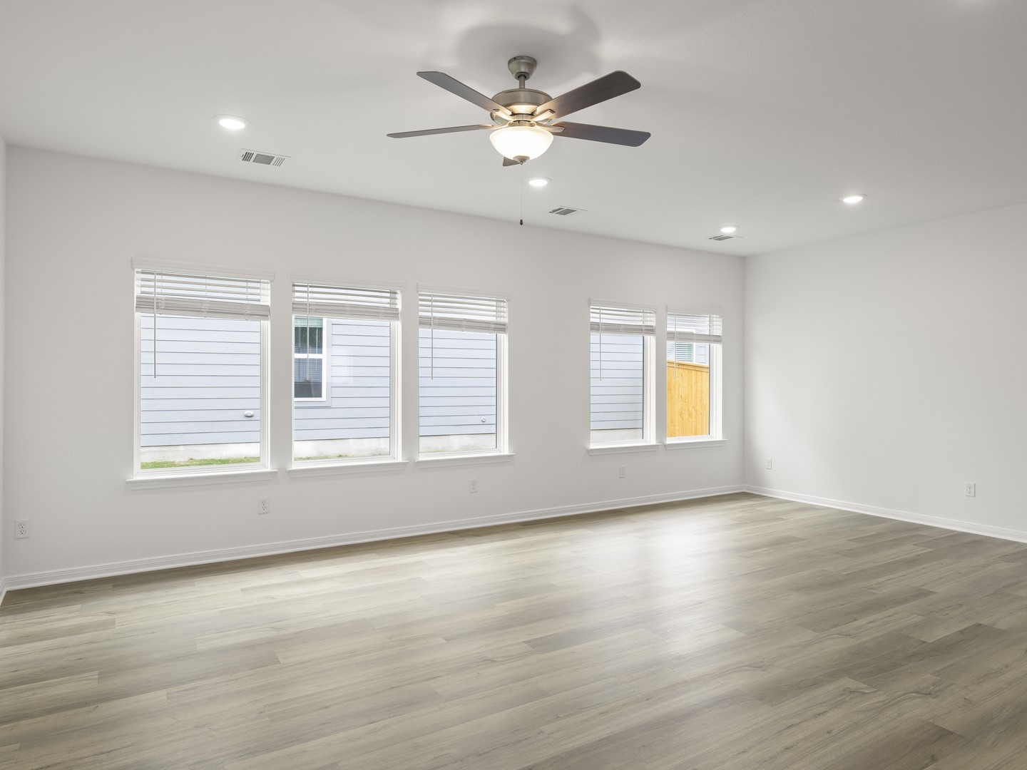 513 Yellow Ribbon Trail Jarrell, TX 76537 - Photo 9 of 23 A well-lit room showcasing neutral flooring and ample natural illumination.