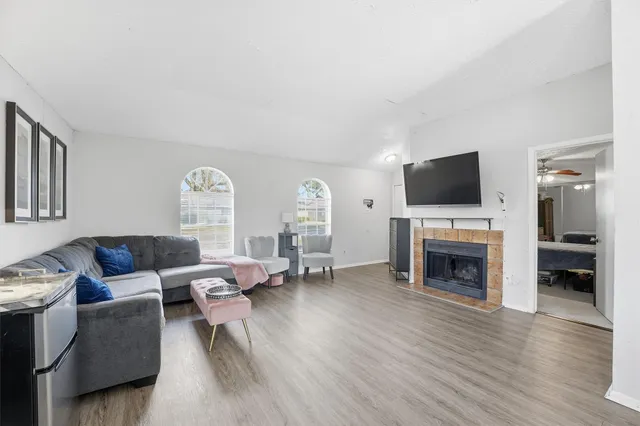 a living room with furniture and a fireplace or television