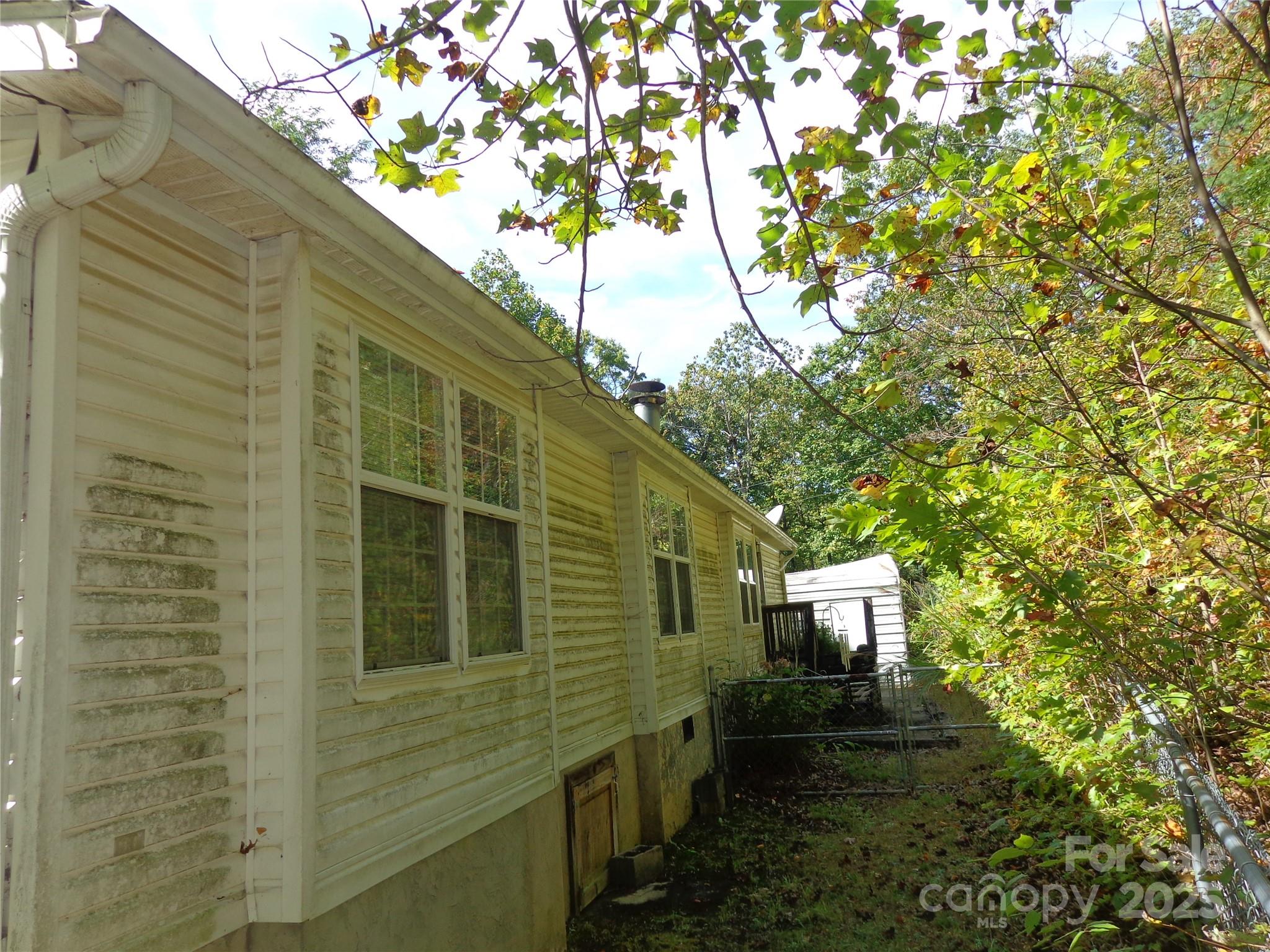 89 Blue Mountain Road Fairview, NC 28730 - Photo 11 of 40 a view of a back yard of the house