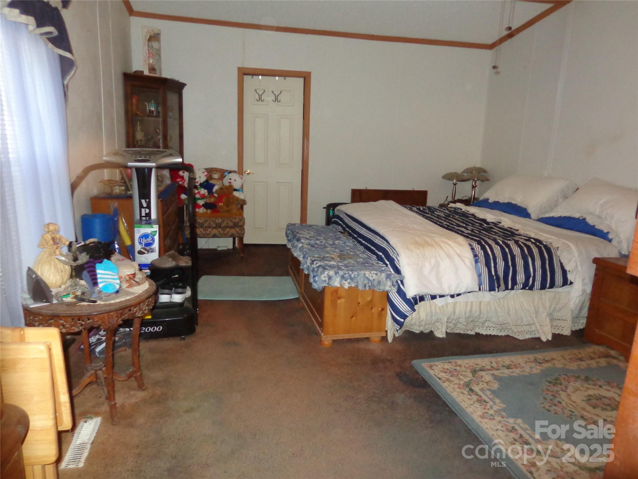 89 Blue Mountain Road Fairview, NC 28730 - Photo 15 of 40 a bedroom with bed and a window