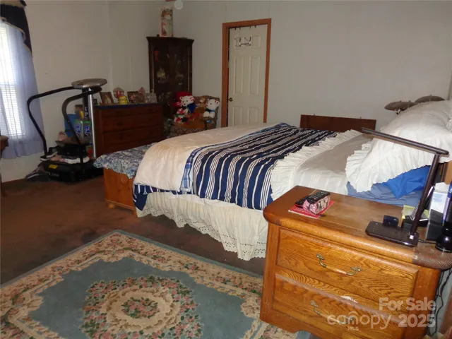 a bedroom with a bed and dresser