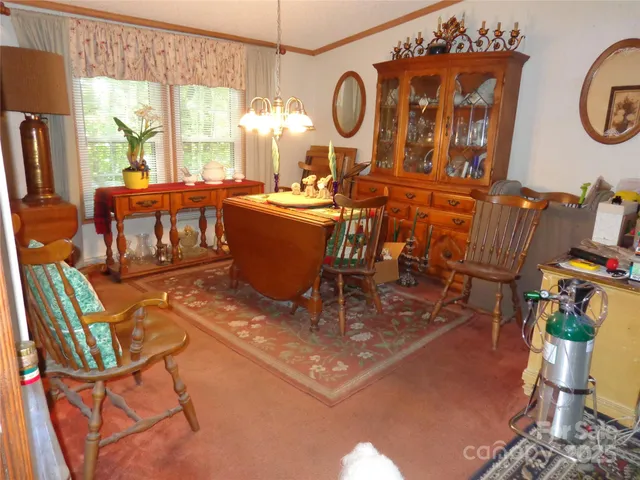 a living room with furniture a window and a chandelier
