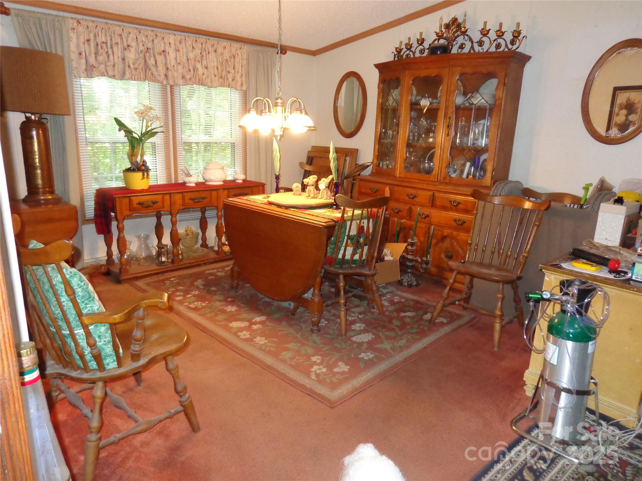 89 Blue Mountain Road Fairview, NC 28730 - Photo 20 of 40 a living room with furniture a window and a chandelier