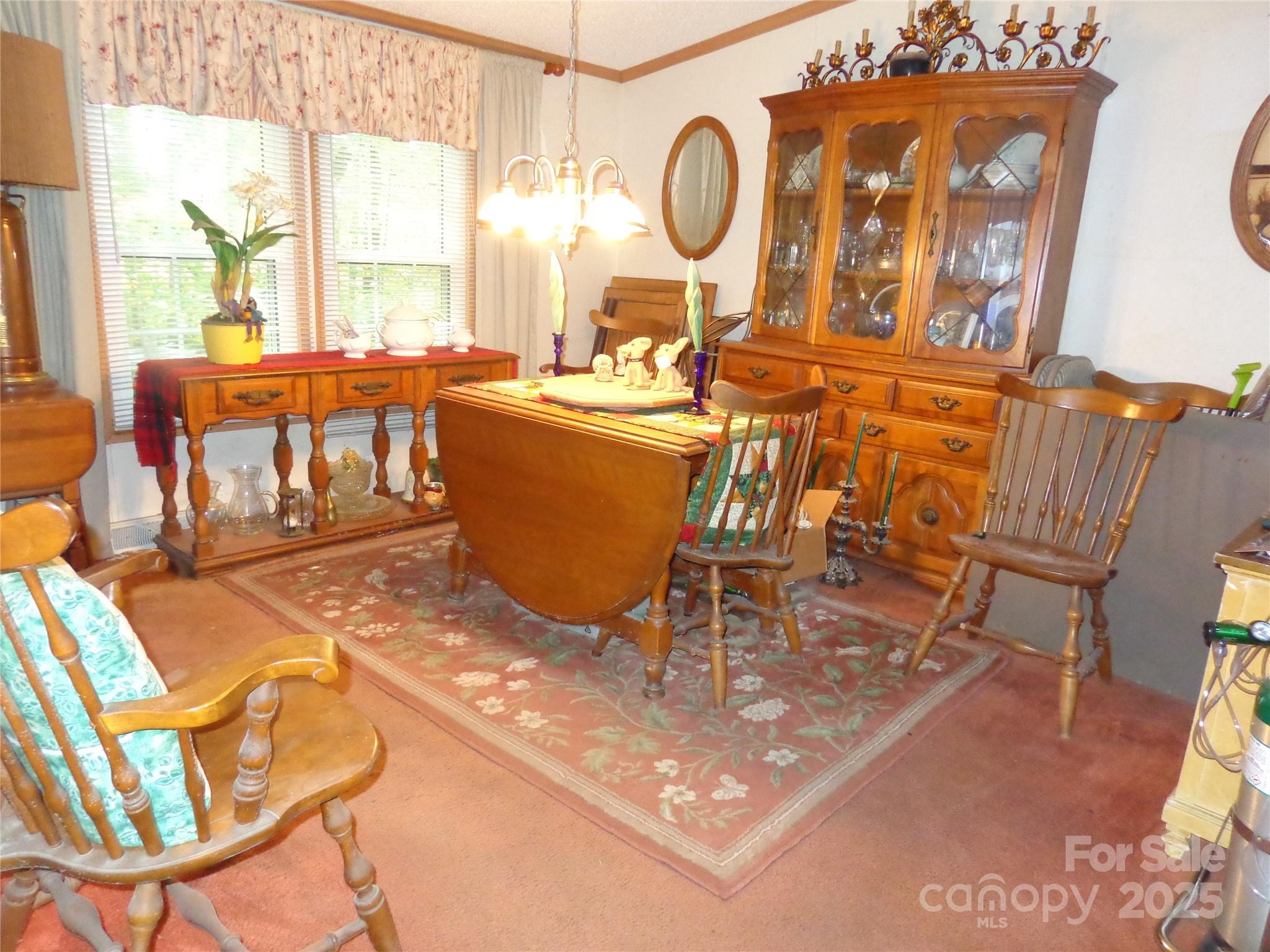 89 Blue Mountain Road Fairview, NC 28730 - Photo 21 of 40 a view of a dining room with furniture a chandelier and wooden floor