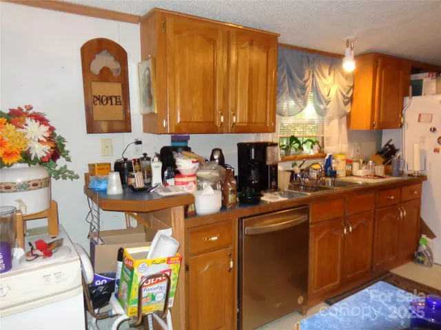a view of living room with stainless steel appliances kitchen island granite countertop a refrigerator and a stove