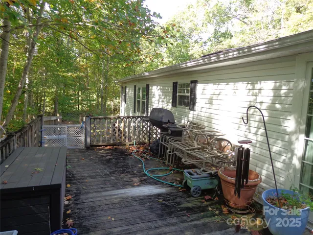 a view of a chairs and table in backyard of the house