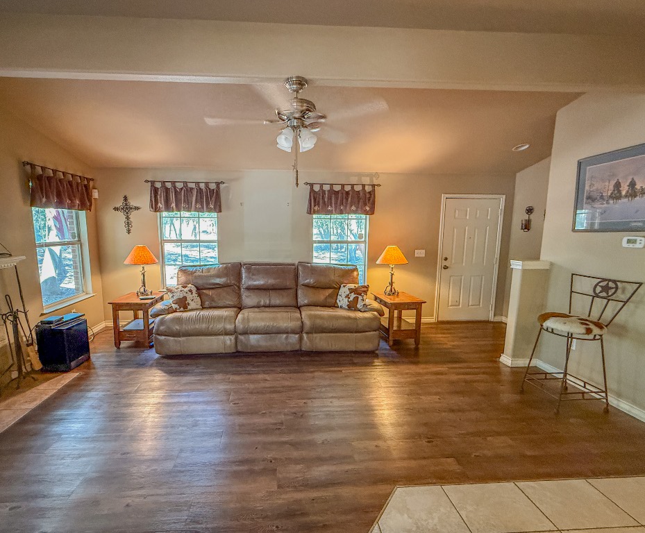 Undisclosed Address Georgetown, TX 78633 - Photo 13 of 37 Living area featuring wood finished floors, ceiling fan, and lofted ceiling