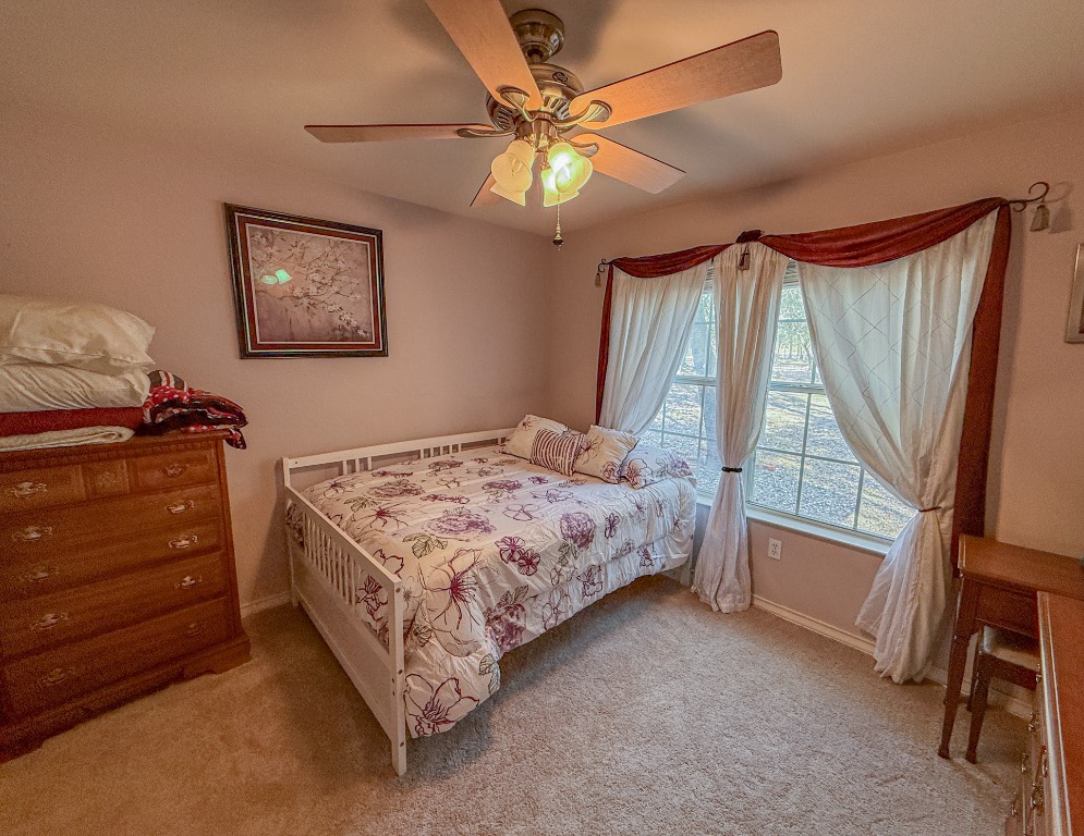 Undisclosed Address Georgetown, TX 78633 - Photo 23 of 37 Bedroom featuring light carpet and a ceiling fan