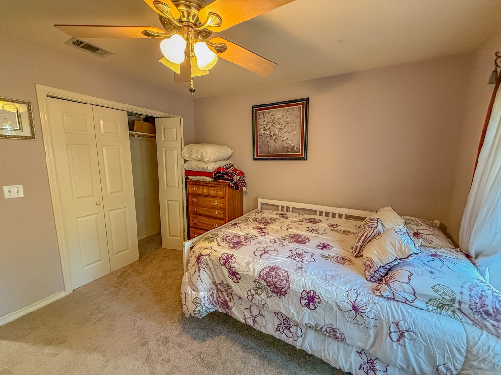 Undisclosed Address Georgetown, TX 78633 - Photo 24 of 37 Bedroom featuring light colored carpet, ceiling fan, and a closet