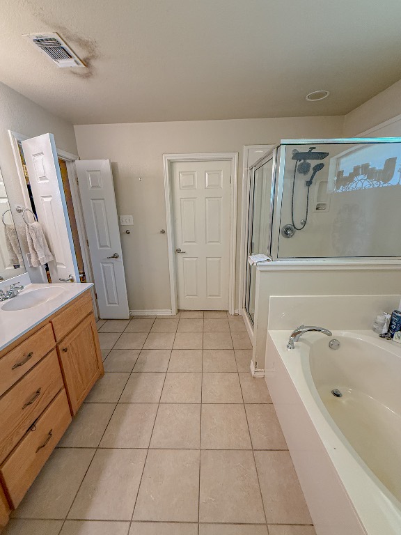 Undisclosed Address Georgetown, TX 78633 - Photo 32 of 37 Bathroom featuring a bath, light tile patterned floors, vanity, and a shower stall
