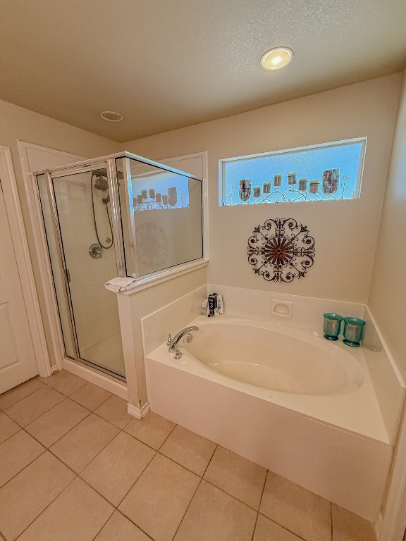 Undisclosed Address Georgetown, TX 78633 - Photo 33 of 37 Full bath with healthy amount of natural light, a garden tub, tile patterned flooring, and a textured ceiling