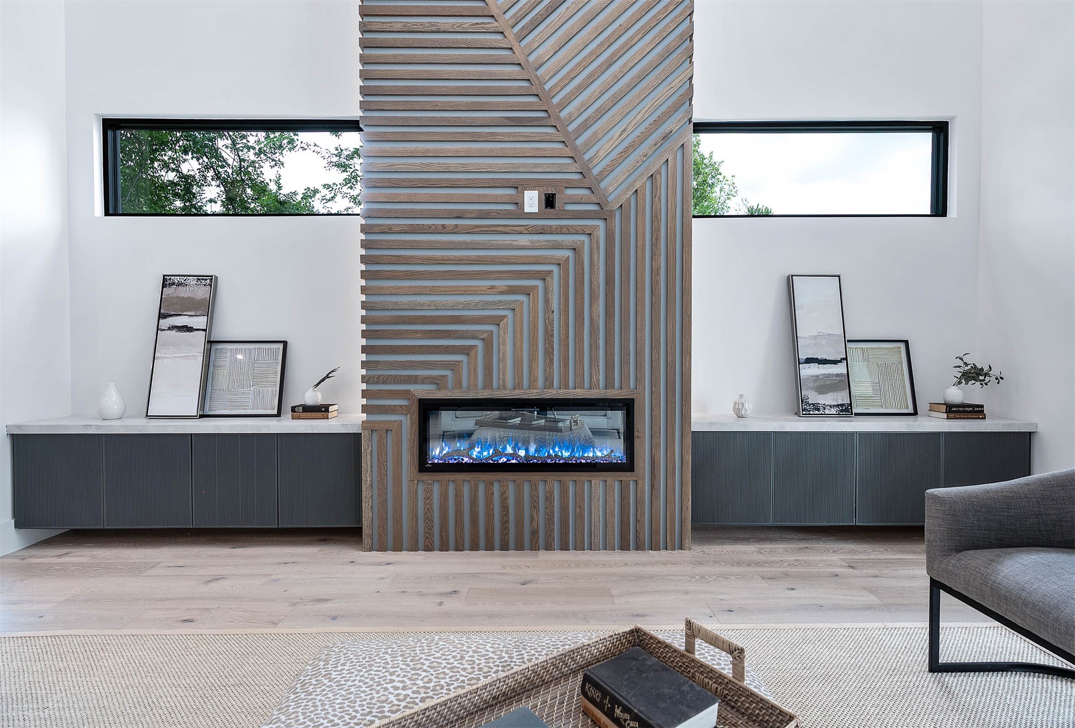 207 West 33rd Street Houston, TX 77018 - Photo 11 of 50 Living room centerpiece features a dramatic 23.5-foot-tall LED fireplace framed by custom millwork, combining striking modern design with elegant craftsmanship to create a captivating focal point.
