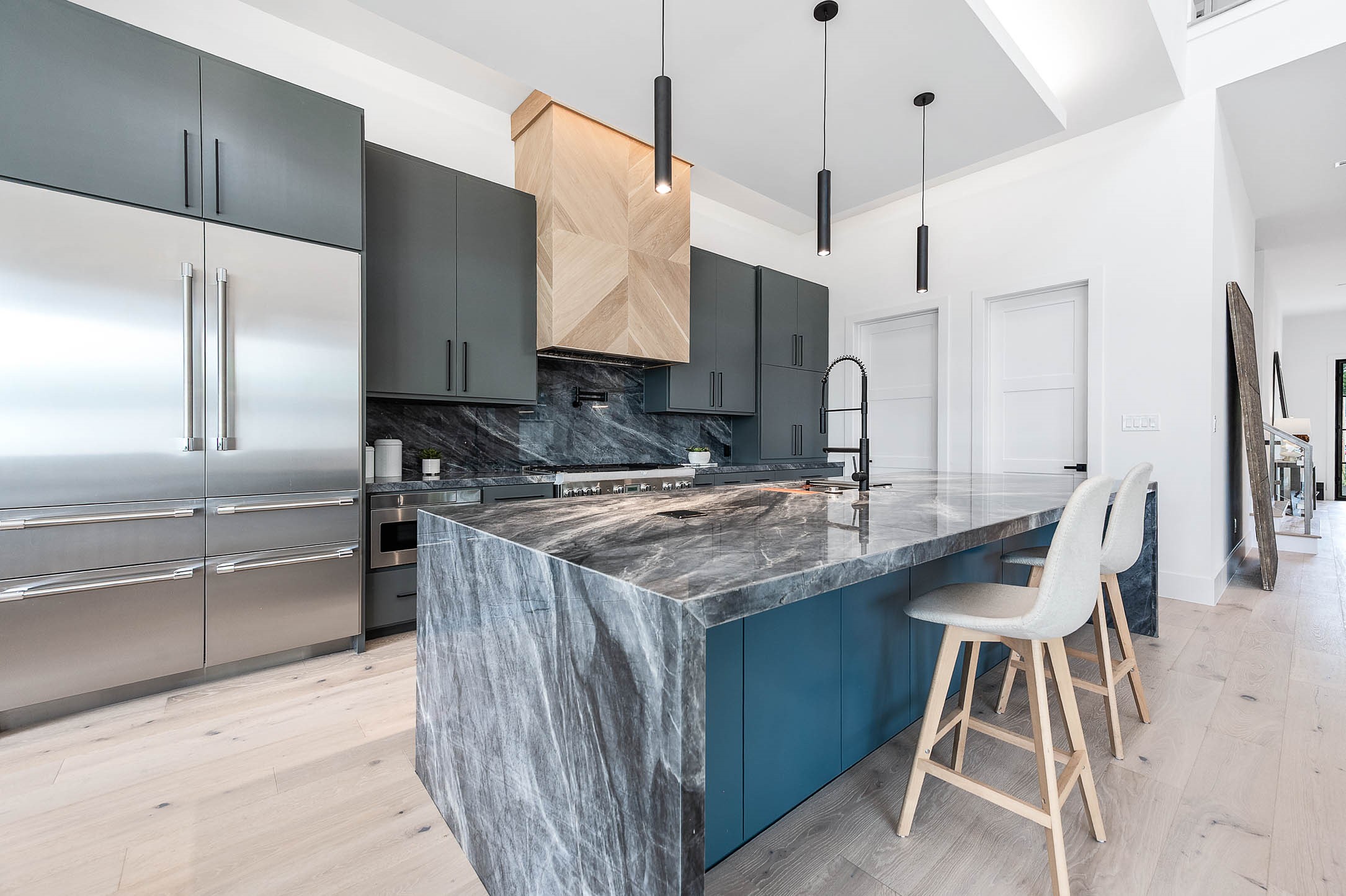 207 West 33rd Street Houston, TX 77018 - Photo 15 of 50 Custom cabinetry and island with striking quartzite waterfall countertops. combining functionality and modern luxury.