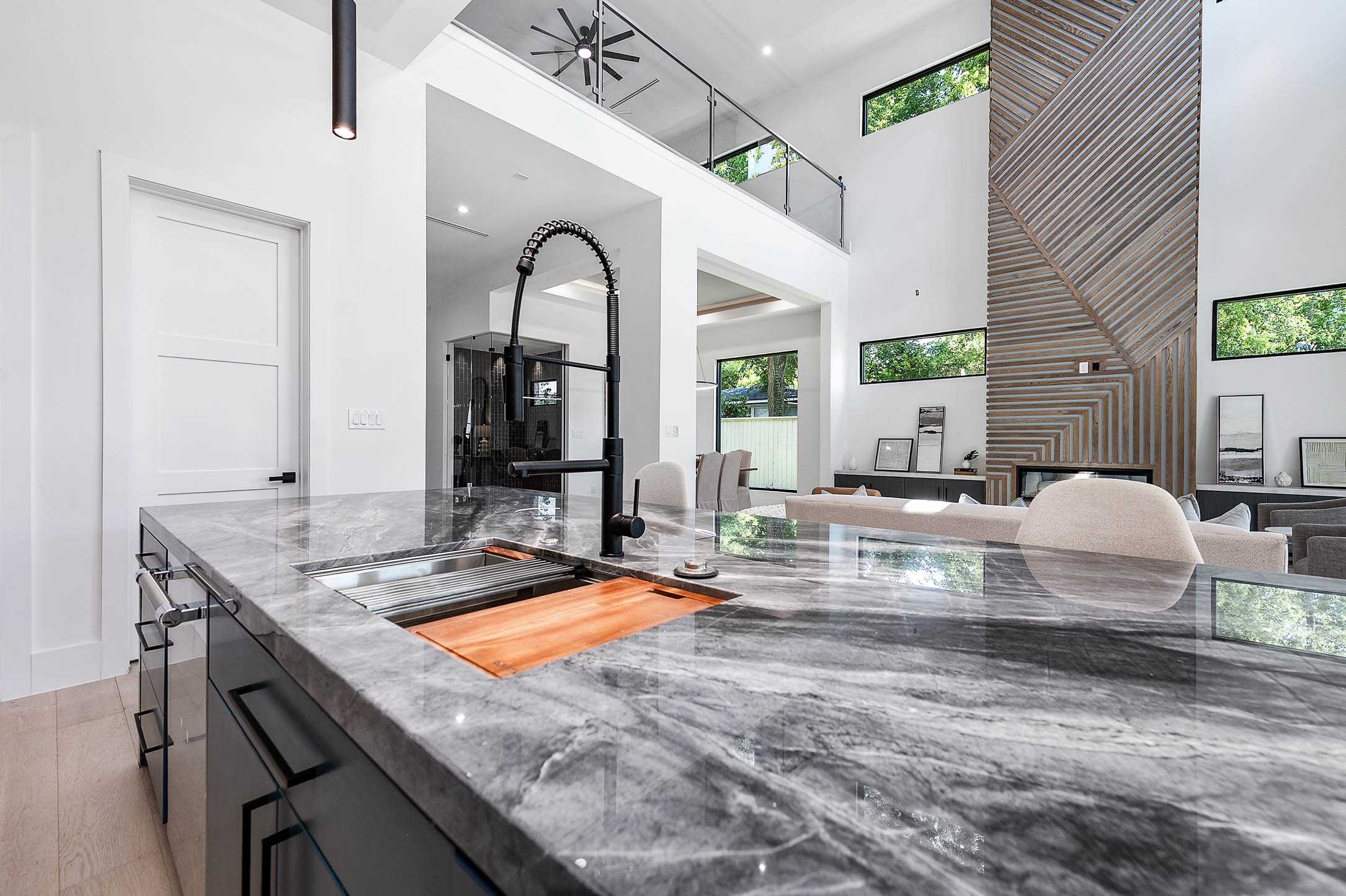 207 West 33rd Street Houston, TX 77018 - Photo 16 of 50 Oversized island with sink equipped with a motion-sensored faucet, built-in cutting board, colander, and additional cutting board, designed for maximum functionality and convenience.