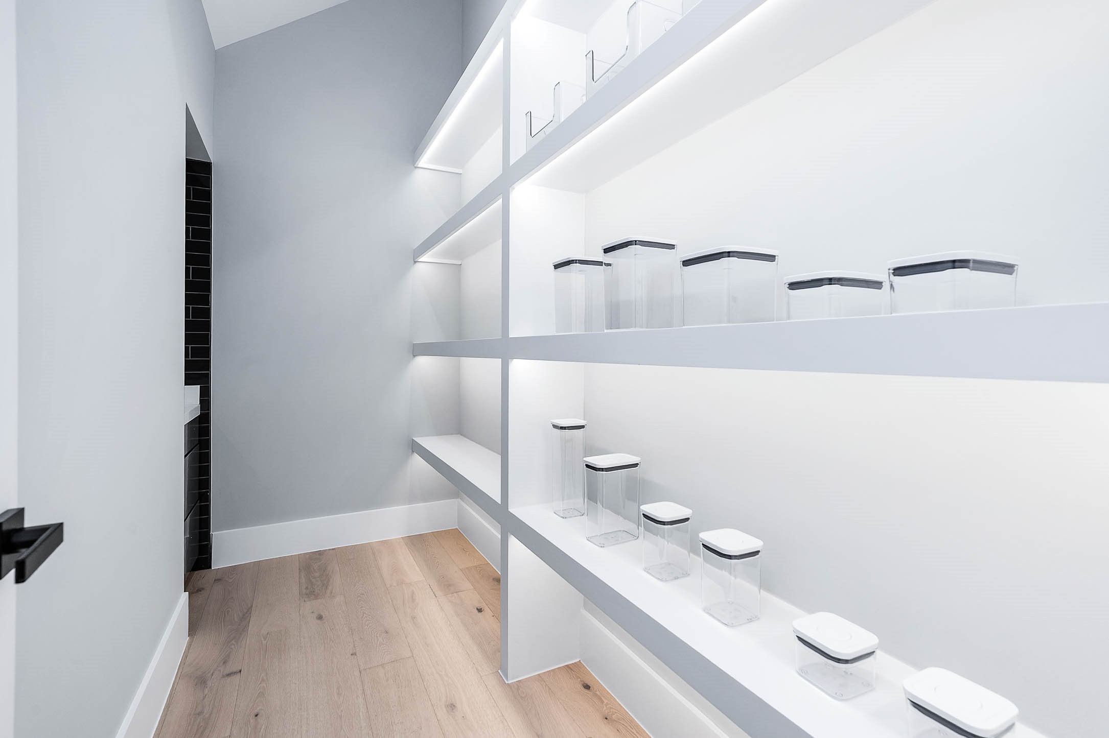 207 West 33rd Street Houston, TX 77018 - Photo 19 of 50 Walk-in pantry featuring LED shelf lighting that highlights organized storage and easy access to all your essentials.