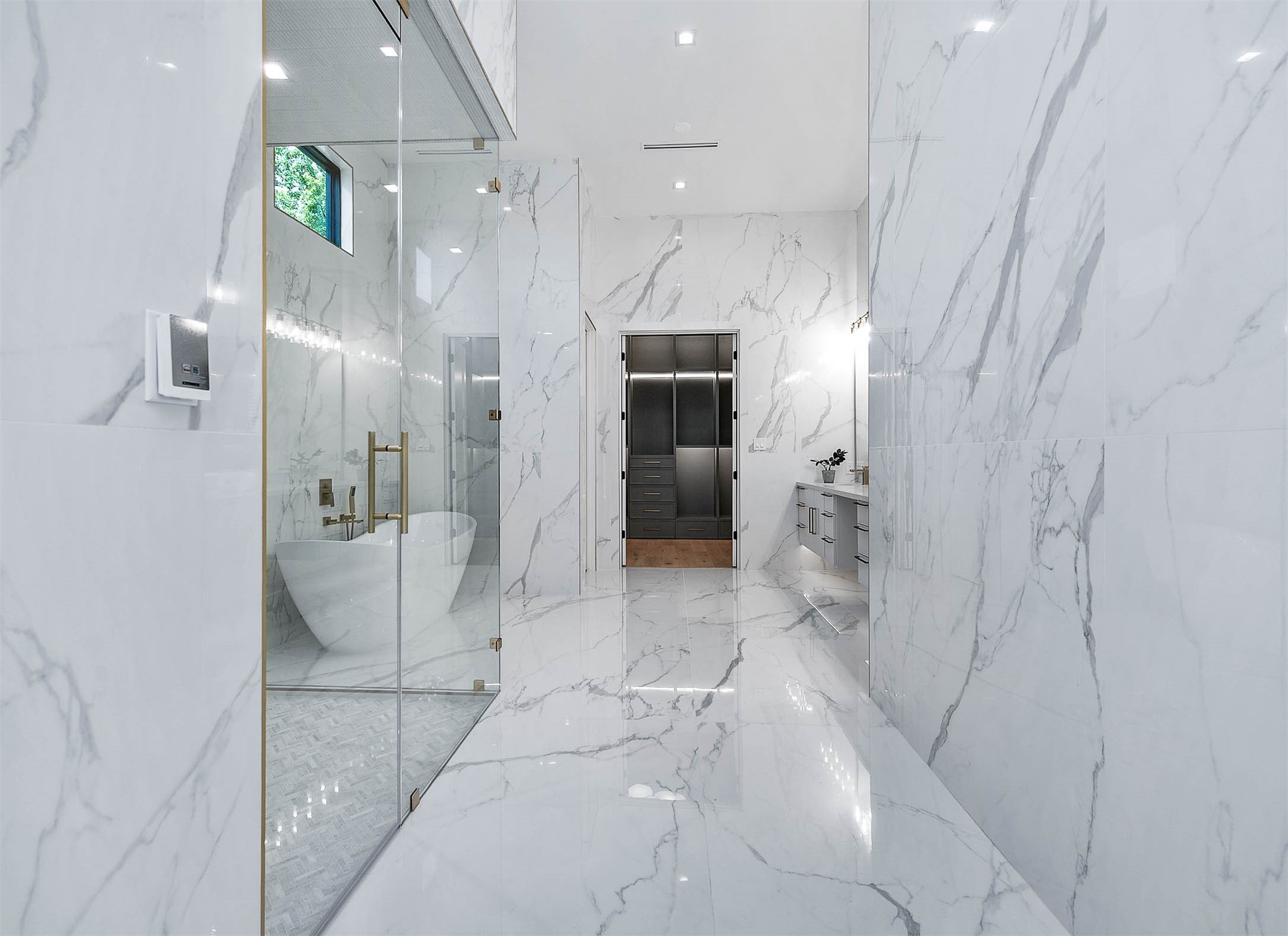 207 West 33rd Street Houston, TX 77018 - Photo 23 of 50 Spa-like primary en-suite bathroom featuring heated floors, floor-to-ceiling porcelain tile, and dual his-and-hers bidet toilets, delivering ultimate luxury and comfort.
