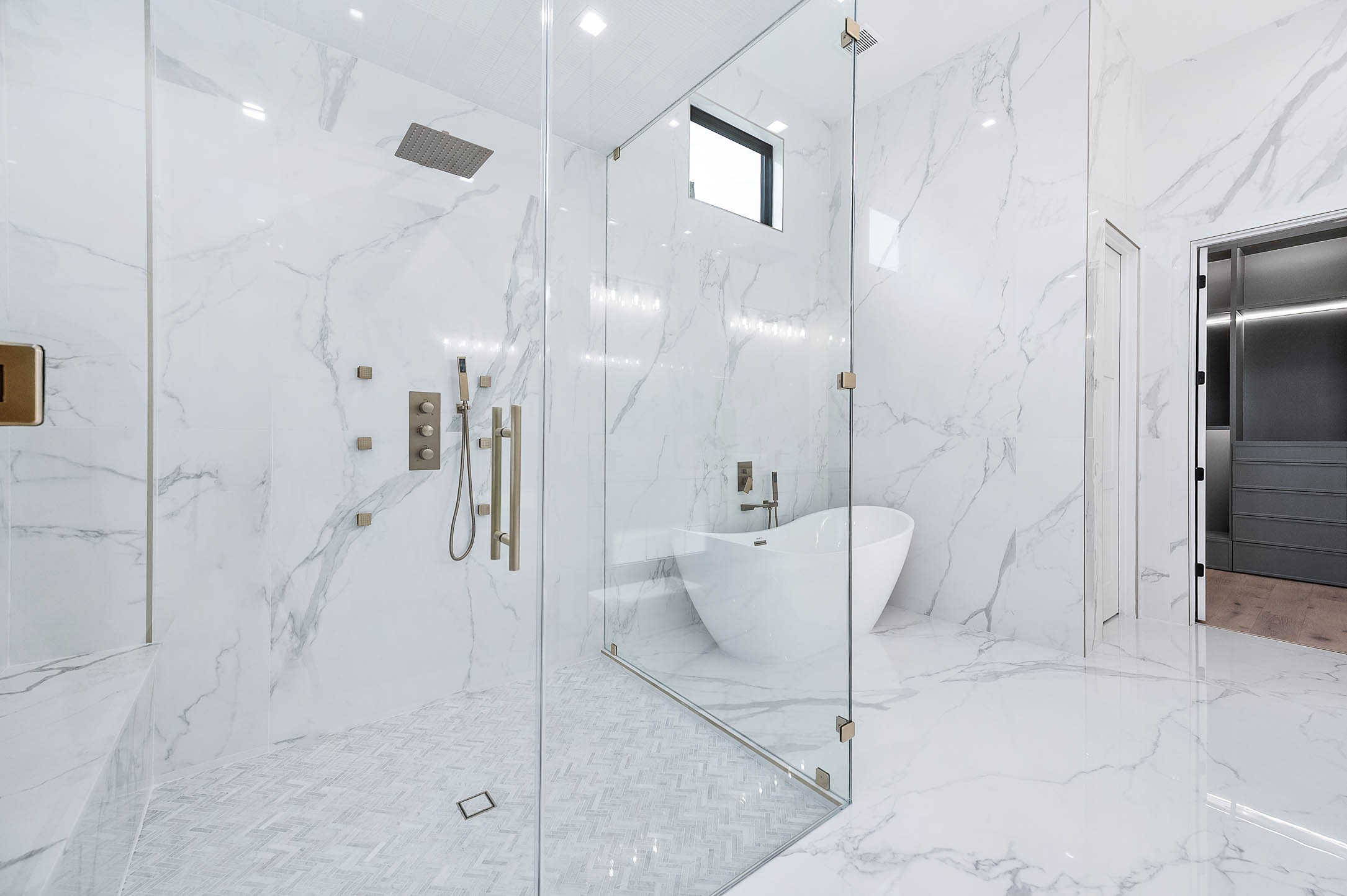 207 West 33rd Street Houston, TX 77018 - Photo 26 of 50 Full-length glass shower featuring a built-in bench, multiple shower heads, and body jets, offering a spa-inspired and relaxing bathing experience.